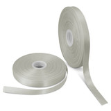 A set of two rolls of personalised ribbon, in a pale green colour, each 15mm wide. One roll is partially unspooled.