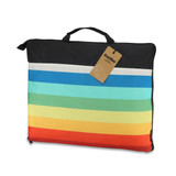 A foldable picnic blanket featuring stripes in black, blue, green, and red, with a carrying handle and branding.
