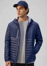 A unisex soft shell jacket in navy blue with a hood and a front zip pocket, worn by a model.