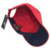A red and navy cap with a branded tag, featuring an interior view showcasing its brushed cotton design.