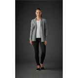 A woman wearing a grey Women's Soho Cardigan over a white top, paired with black leggings. The background is dark.