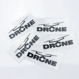 Five black stickers featuring the word "DRONE," set against a clear background, showcasing a simple design.