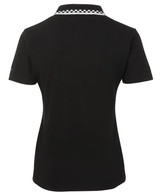 A black chef polo with a white checkered collar, featuring a logo on the back.