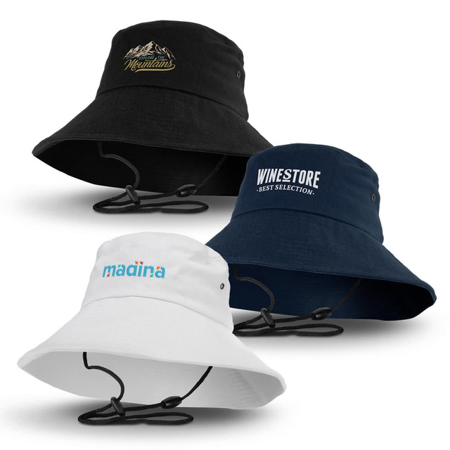 A set of three Yuma bucket hats in black, navy, and white, each featuring distinct logos and adjustable chin straps.
