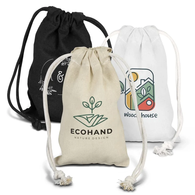 Three small cotton gift bags in black, white, and natural tones, each with a different design and logo.