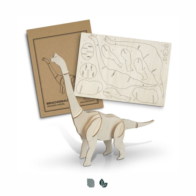 A Brachiosaurus wooden model in natural wood colour, with assembly pieces and packaging displayed behind.