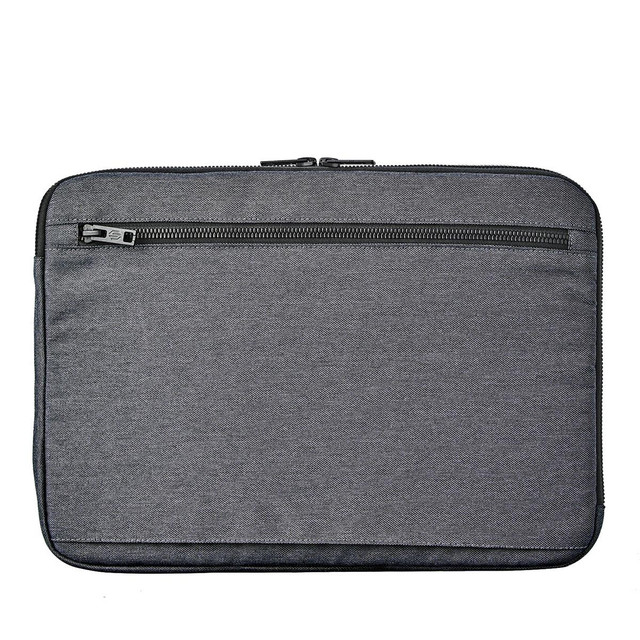 A laptop sleeve in grey fabric featuring a zippered pocket on the back and a sleek design.
