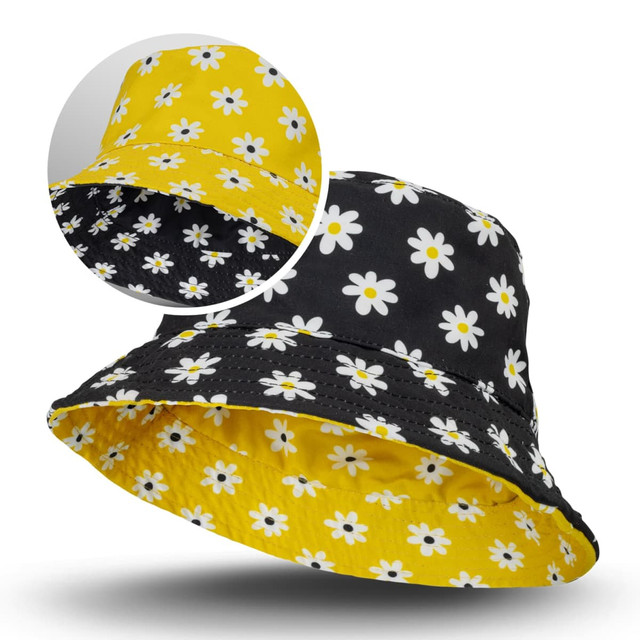 A reversible bucket hat featuring a yellow floral pattern on one side and a black floral pattern on the other.
