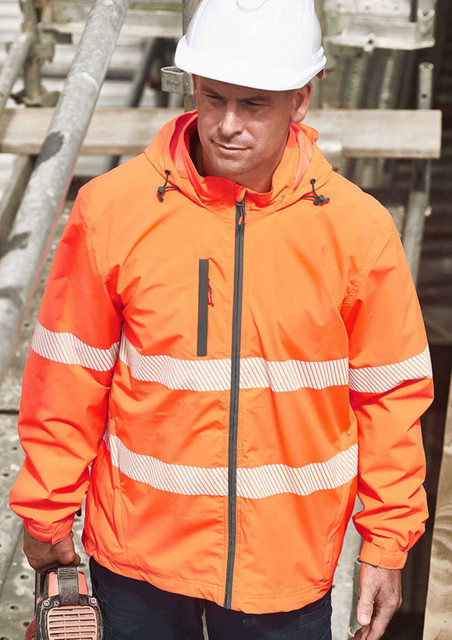 An orange packable rain jacket with reflective strips, worn by a person in a hard hat, standing near scaffolding.