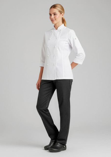 A model wears a white chef's jacket paired with black pants, showcasing a professional culinary uniform.