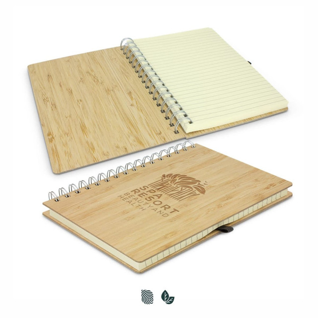 A bamboo notebook with a spiral binding, featuring a natural finish and blank pages inside. It has a logo on the cover.
