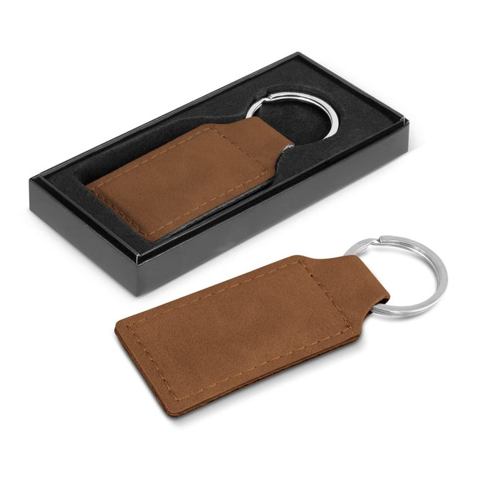 A brown leather key ring with a silver metal attachment, presented in a black gift box.
