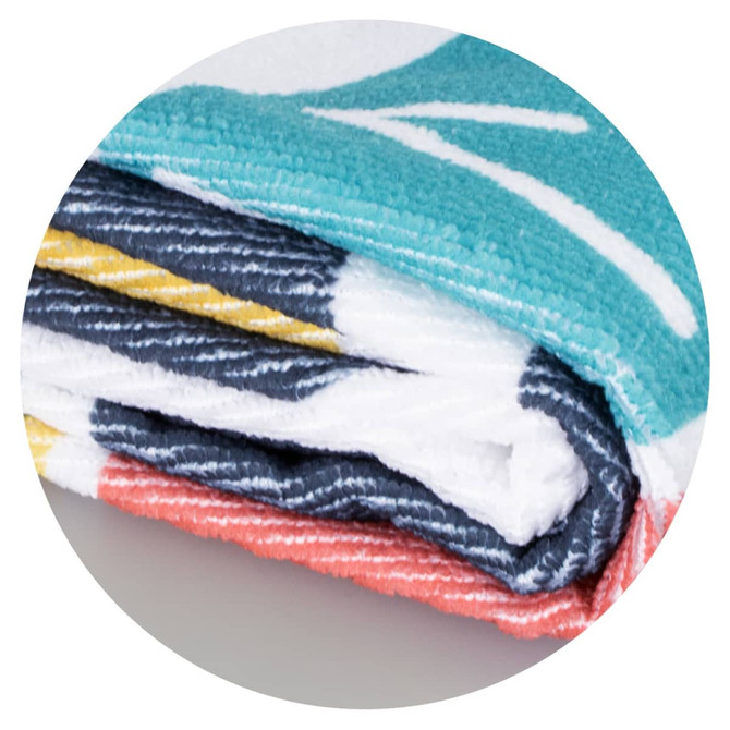 A folded beach towel featuring a vibrant design with teal, coral, and navy colours, displaying a logo.