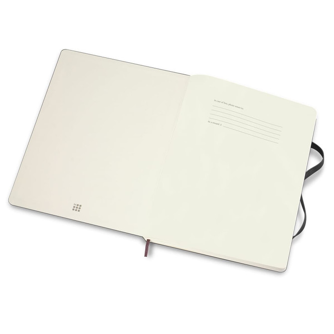An extra-large, soft cover Moleskine notebook with blank pages and a ribbon bookmark, featuring a black exterior.