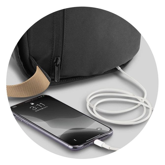 A black bag with a charging port and a white charging cable connected to a smartphone.