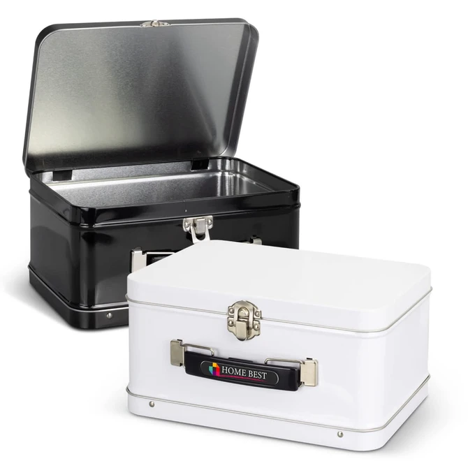 A black and a white tin lunch box with metal clasps and an interior lining, both featuring logos on the exterior.