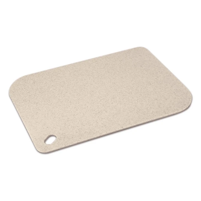 A light beige chopping board with a rounded corner and a hole for hanging. It features a smooth, speckled surface and has a logo.
