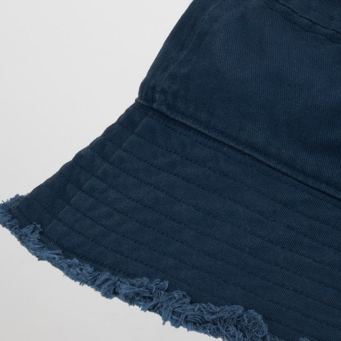 A navy blue raw edge bucket hat featuring a frayed brim and textured fabric. Logo visible on the hat.