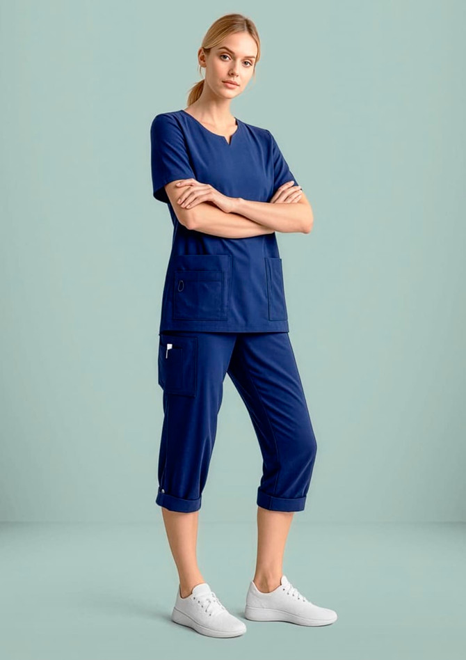 A navy blue women's scrub top displayed on a model, featuring a round neck and short sleeves.