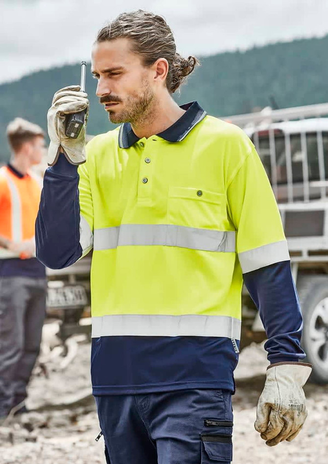 A men's high visibility long sleeve polo in bright yellow and navy, featuring reflective hoop tape and a pocket.