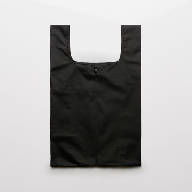 A black reusable grocery bag with a simple design and a button closure at the top.
