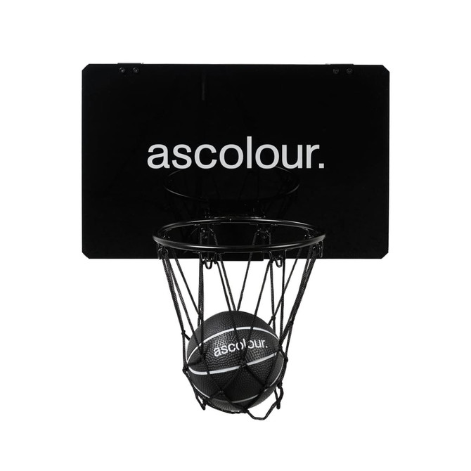 A mini basketball set featuring a black backboard, net, and a black basketball, with a logo on the backboard.