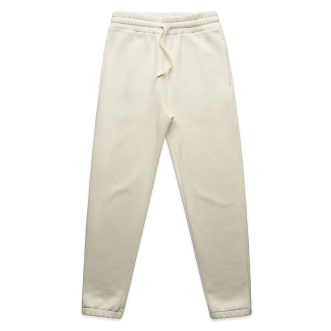 Cream-coloured track pants with an elastic waistband and two side pockets. The pants feature a logo.