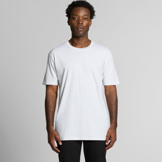 A plain white t-shirt with short sleeves, featuring a logo on the front, modelled by a person standing against a neutral background.