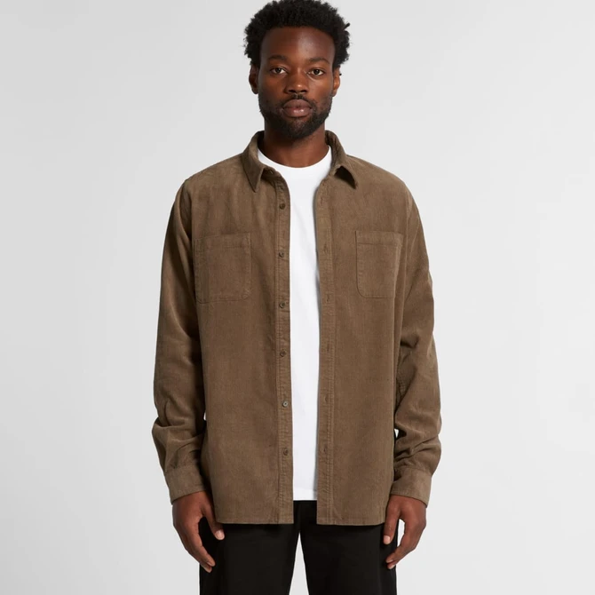A button-up cord shirt in a muted brown colour with two chest pockets, worn over a white t-shirt.