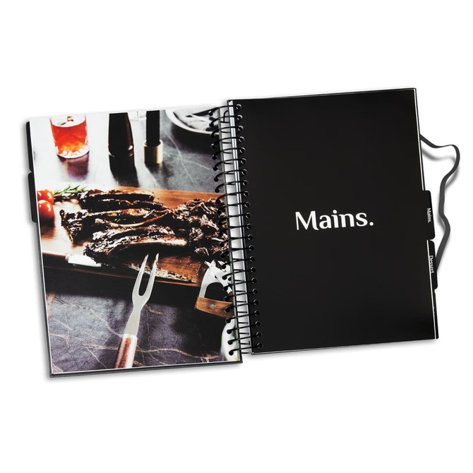 A black spiral-bound recipe journal with a photo of grilled meat on a wooden board and a fork.