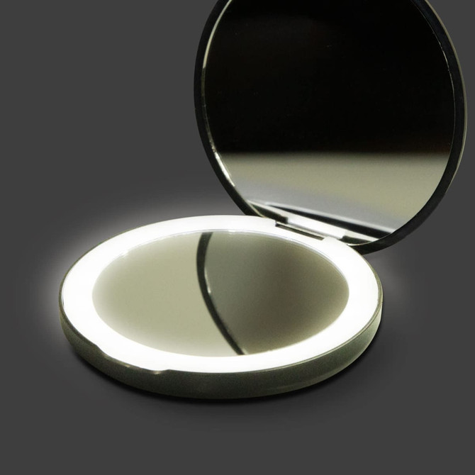 A round, silver compact mirror with an LED light surrounding the edge, opened to reveal a reflective interior.