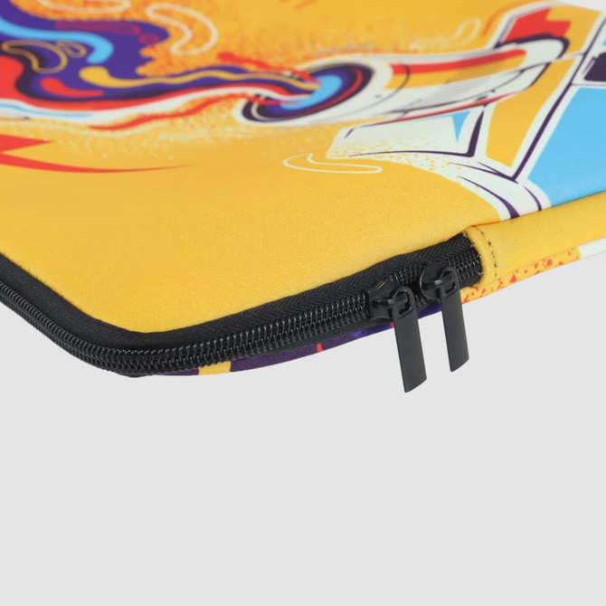 A yellow laptop sleeve featuring vibrant, abstract patterns and a black zipper. It has a decorative design with multiple colours.