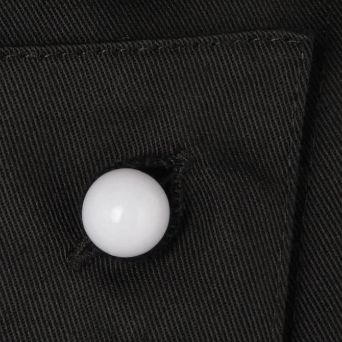 A black fabric close-up featuring a white button, showcasing a clothing accessory in a textured finish.