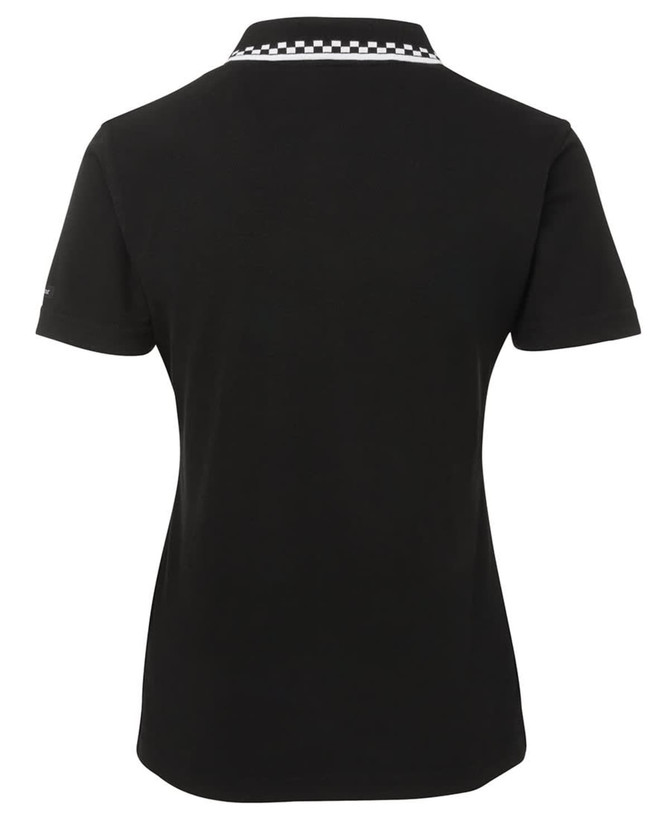 A black chef polo with a white checkered collar, featuring a logo on the back.