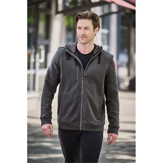 A man wearing a charcoal grey zip-up fleece hoody with a hood, walking in an urban setting.