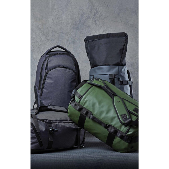A collection of backpacks and duffel bags in dark grey and green, featuring a logo on one bag.