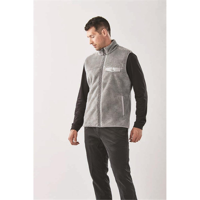 A men's grey sherpa fleece vest with a front zipper and a pocket, modelled by a man.