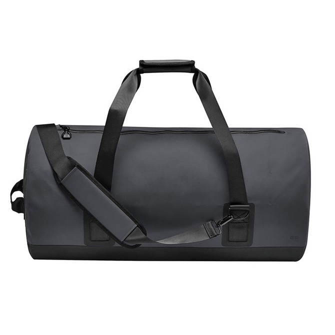 A waterproof duffel bag in dark grey with sturdy handles and adjustable shoulder strap, featuring a logo.