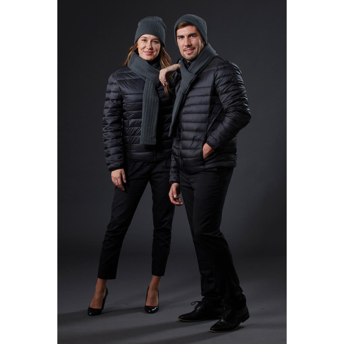 A black puffer jacket worn by two models, paired with grey beanies and scarves, against a dark background.