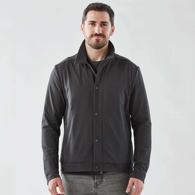 A black men's jacket with a collared design, featuring buttons and a logo. The model stands against a plain background.