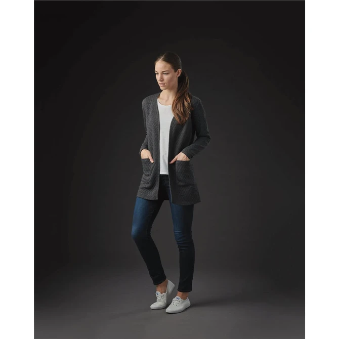 A model wearing a charcoal grey women's Chelsea open cardigan over a light top and dark jeans, featuring pockets.