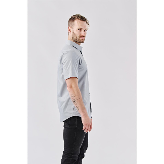 A grey short-sleeve button-up shirt is displayed on a model standing sideways against a plain background.