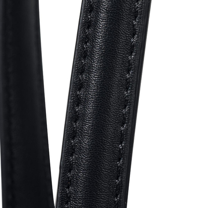 Close-up of a black, textured strap from a tote bag, featuring detailed stitching. The bag has a logo on it.
