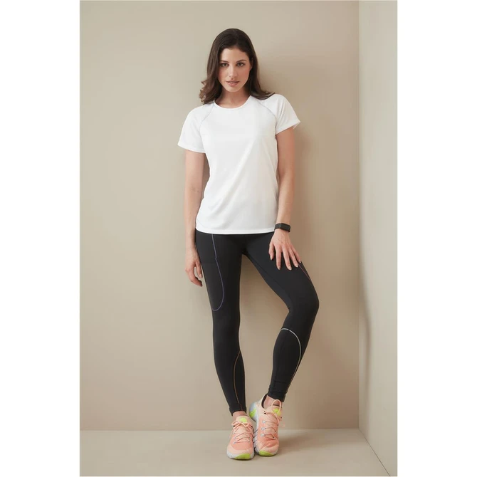A white women's athletic t-shirt is worn with black leggings and sporty shoes, featuring a logo.