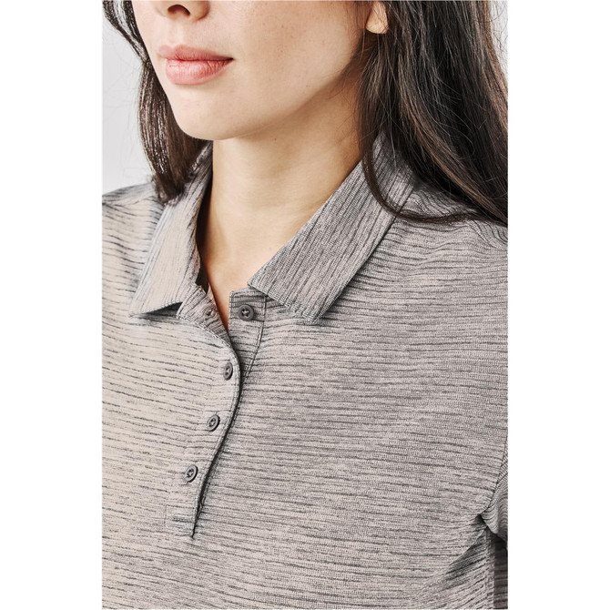 A close-up of a woman's grey polo shirt featuring a collar and button detail, with a logo visible.
