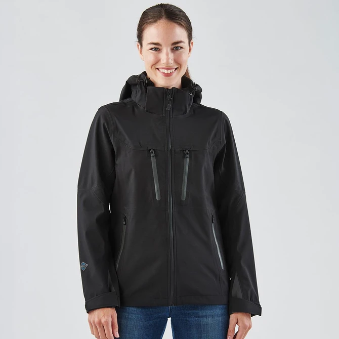 A black women's softshell jacket featuring two zippered pockets and a hood, with a branding logo on the sleeve.
