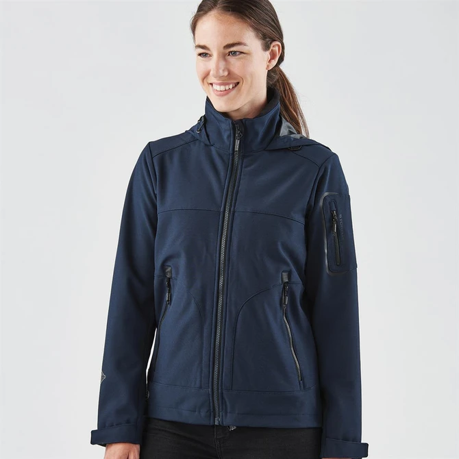 A women's softshell jacket in navy blue, featuring a zip front, multiple pockets, and a logo.