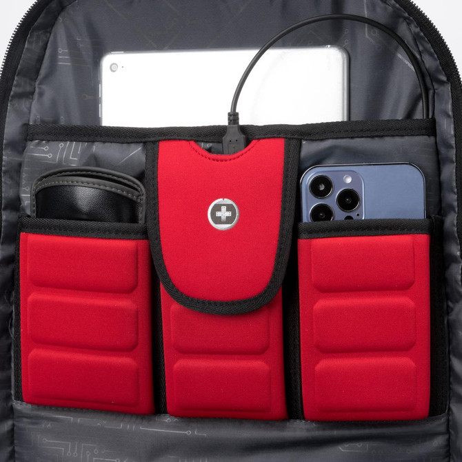 A red and black backpack interior featuring pockets for a tablet and smartphone, with a cable connected.