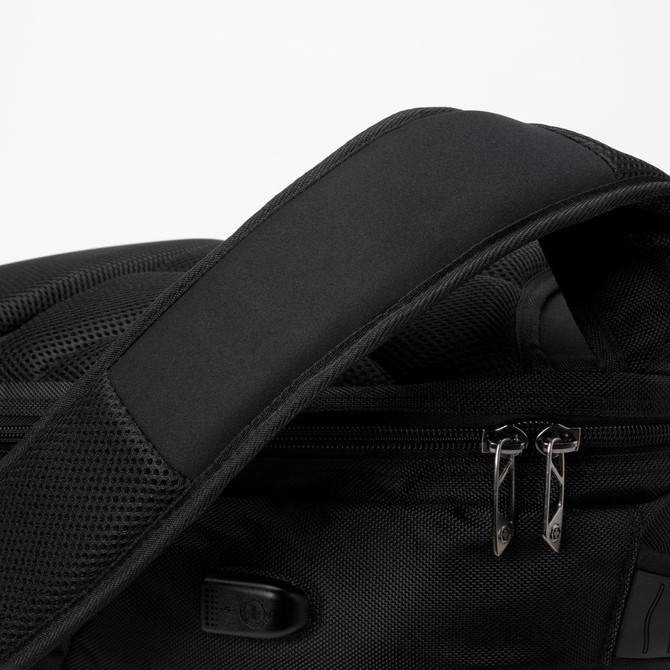 A black backpack with a padded shoulder strap and metal zippers, featuring mesh detailing.