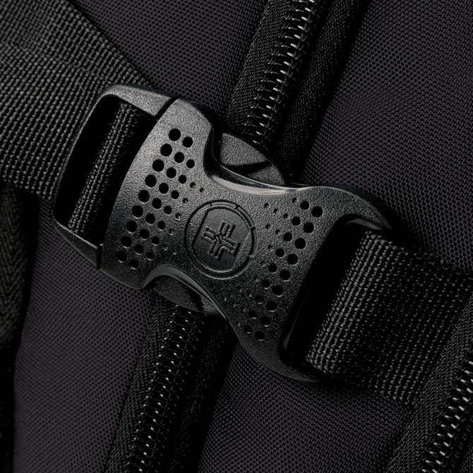 A close-up of a black buckle and strap on a backpack, showcasing its sturdy design and material.